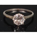A white metal and diamond solitaire ring, the claw set old brilliant weighing approx 1.
