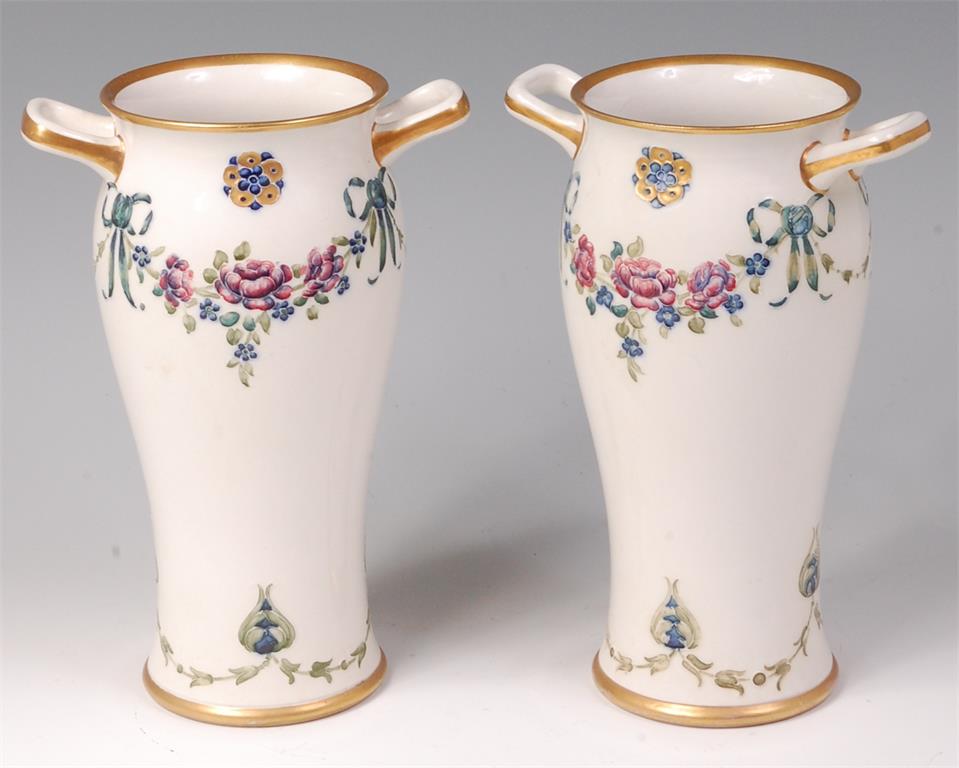 A pair of Moorcroft MacIntyre glazed pottery twin handled vases, in the 18th century pattern,