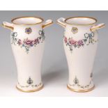 A pair of Moorcroft MacIntyre glazed pottery twin handled vases, in the 18th century pattern,