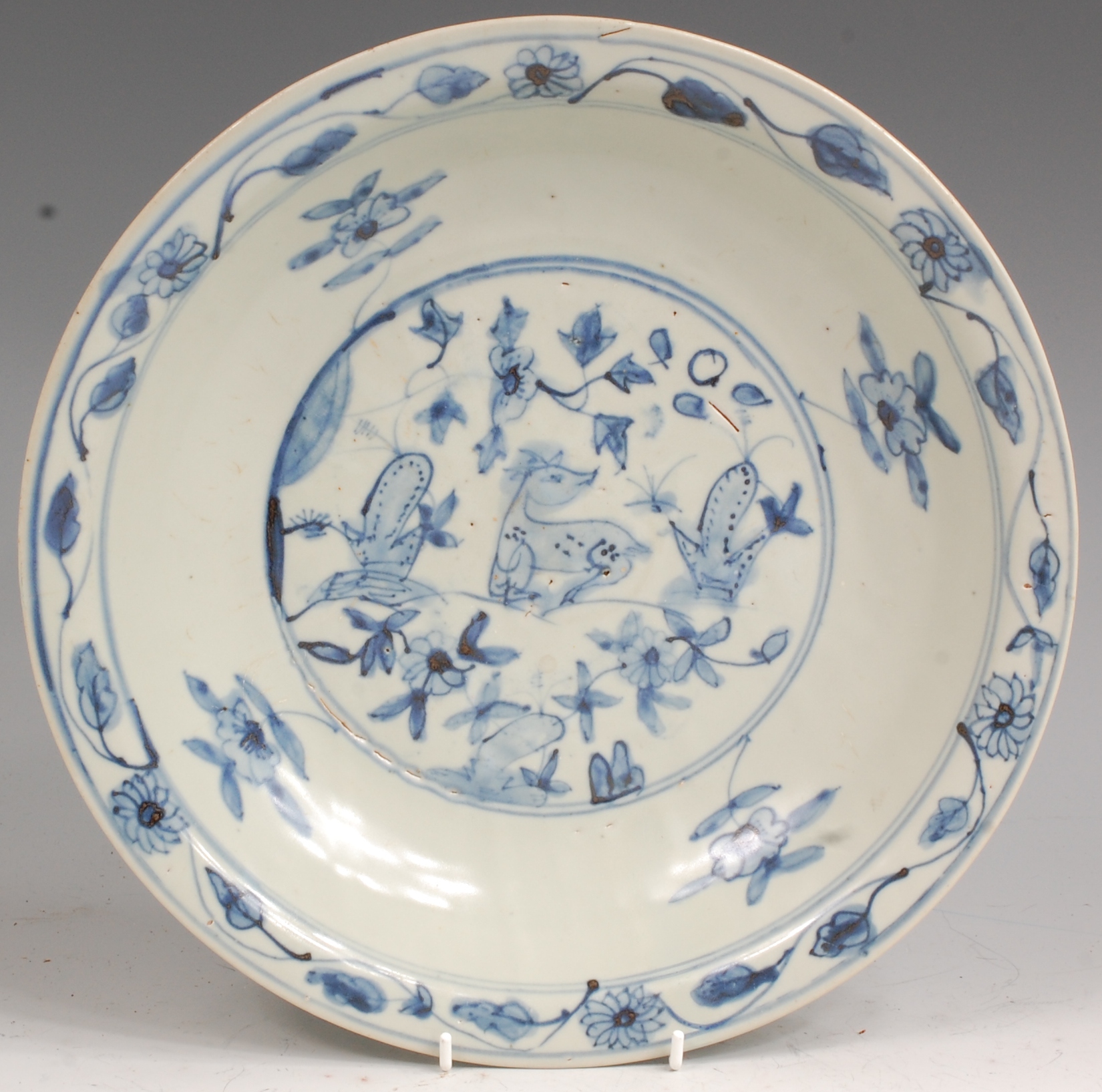 A large Chinese Swatow ware blue and white pottery charger, probably provincial Ming dynasty,