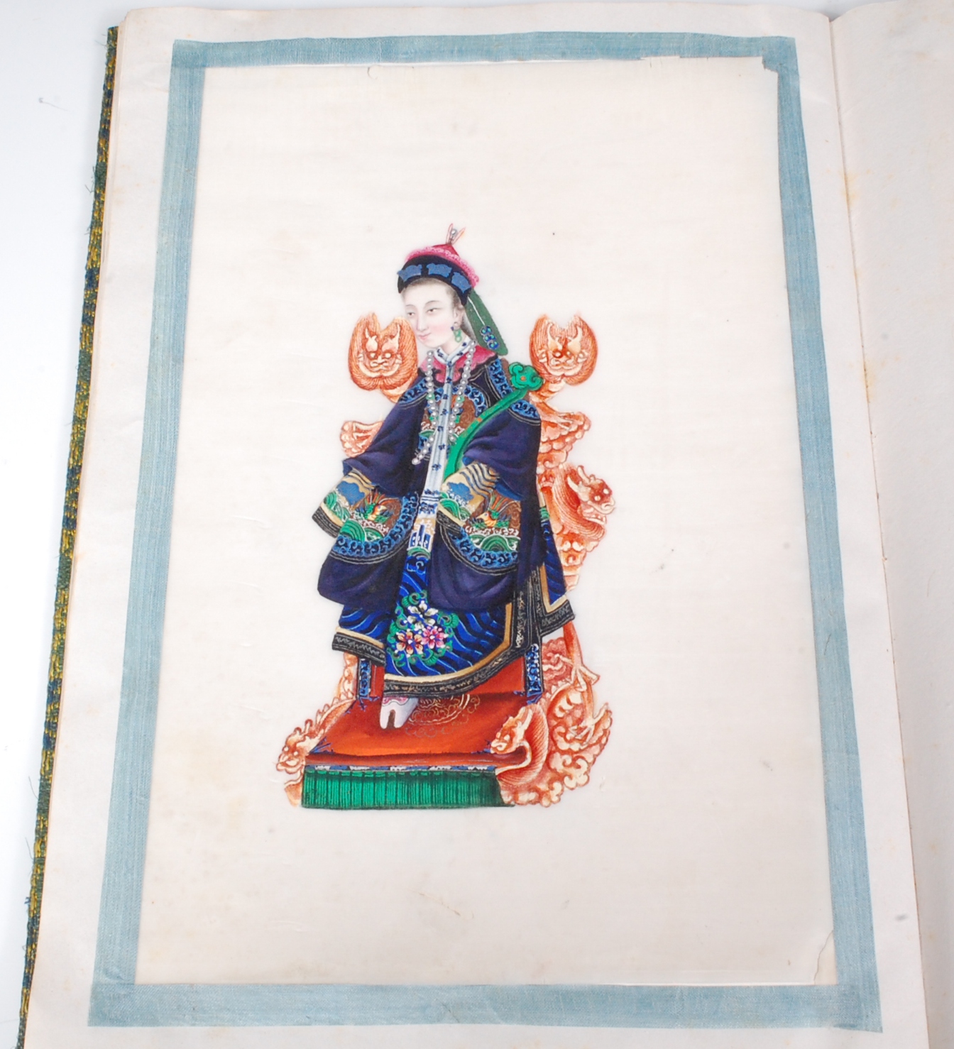 Two Chinese cloth covered scrap albums containing late Qing Dynasty pith paintings,