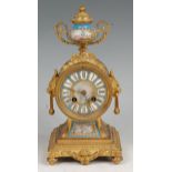 A late 19th century French gilt bronze and porcelain inset mantel clock, having urn finial,
