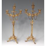 A pair of circa 1900 French gilt metal japonisme three-light candlesticks,