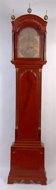 A good mahogany longcase clock, the domed hood with pierced fret carving,