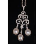 A contemporary 18ct white gold, diamond and pearl three tier pendant,