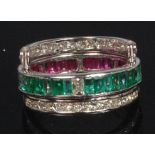 A contemporary white metal, ruby, emerald and diamond set triple eternity ring,