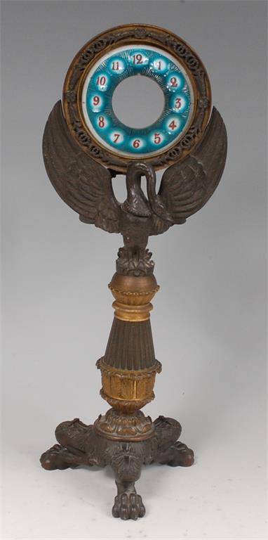 A Regency period bronze and gilt bronze 'candle' clock case (lacking movement),