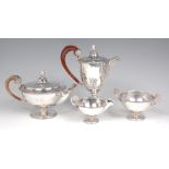 A George V silver four piece tea and coffee set, comprising; pedestal teapot, coffee pot,