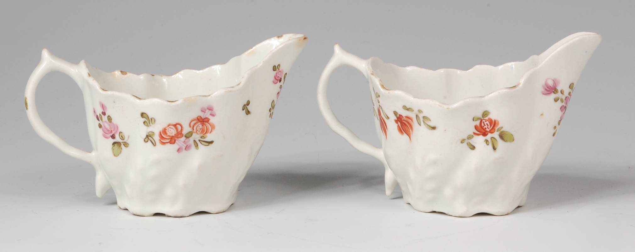 A pair of Lowestoft porcelain cream boats, of low Chelsea ewer form,