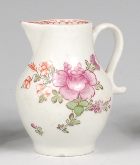 A Lowestoft porcelain sparrowbeak cream jug, polychrome decorated with stylised roses and fuchsias,