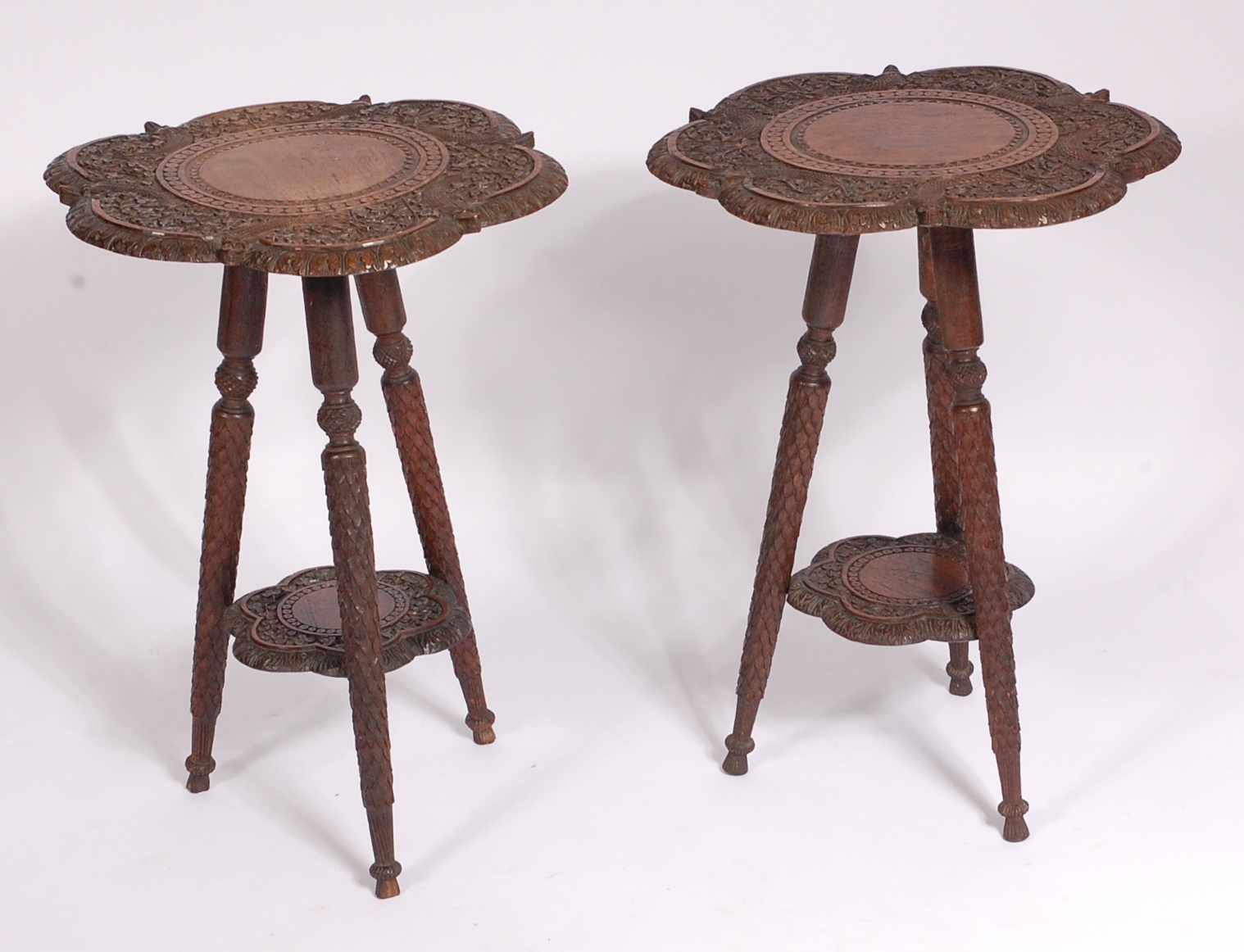A pair of circa 1900 Indian carved teak occasional tables, of shaped circular form,