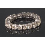 A white metal and diamond eternity ring, arranged as 18 gate links,