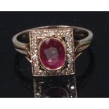 A white metal, ruby and diamond set dress ring,