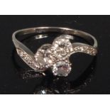 An 18ct white gold and diamond three stone dress ring,