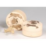 A pair of Japanese Meiji period ivory dressing table jars and covers,