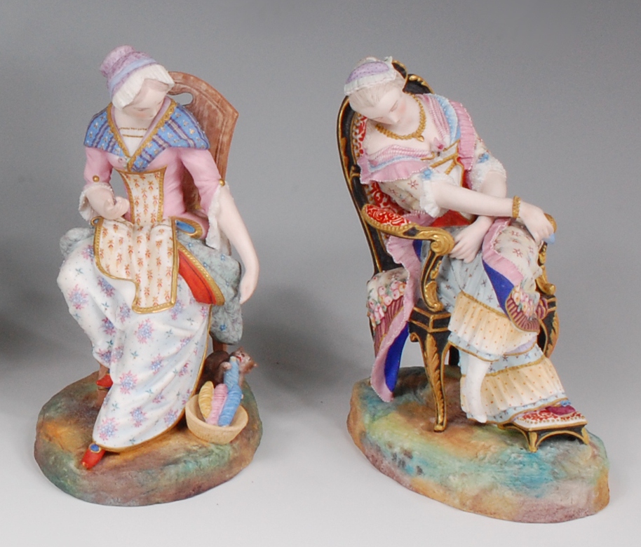 A pair of Victorian George Jones bisque figures, modelled as seated maidens, one with attendant cat,