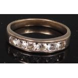 An 18ct white gold and diamond set dress ring, arranged as six channel set brilliants,