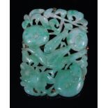 A Chinese celadon and green jade brooch, in yellow metal mount, carved as a bird amidst fruit,