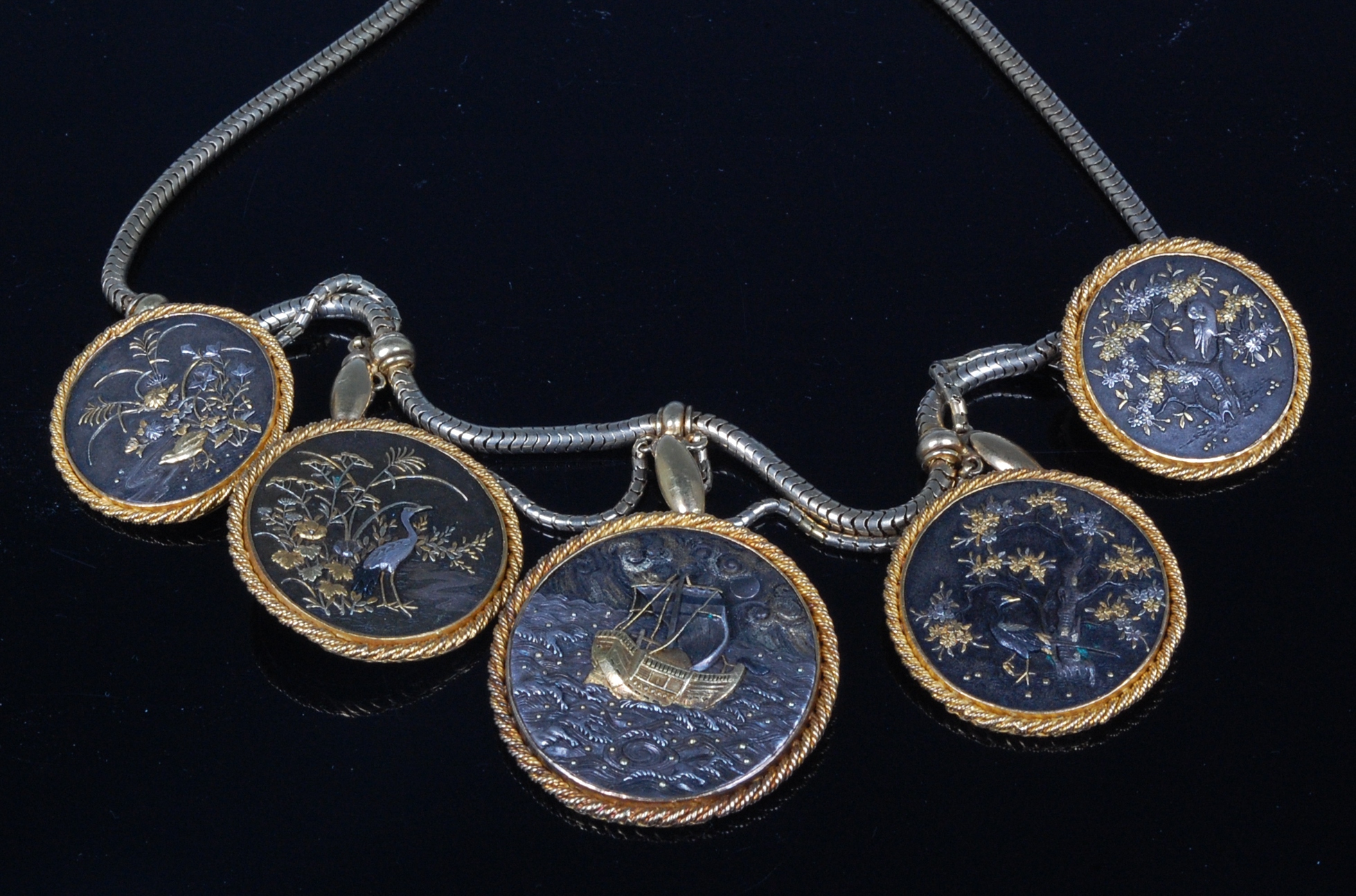 A Japanese Meiji period shakudo medallion set necklace,