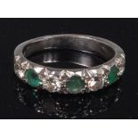 An 18ct white gold, emerald and diamond half eternity ring,