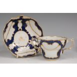 A Worcester porcelain twin handled chocolate cup and saucer, the cup having pierced twin handles,