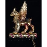 An 18ct gold and ruby set brooch, in the form of a standing griffin,