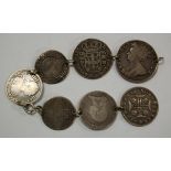 A bracelet made from seven silver coins to include; 1707 Queen Anne half crown,