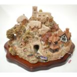 A large Lilliput Lane model of St Peter's Cove on a wooden plinth (boxed)