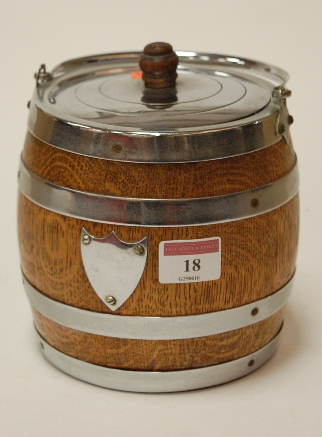 A 1920s oak and silver plated biscuit barrel and cover