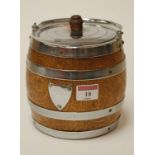 A 1920s oak and silver plated biscuit barrel and cover