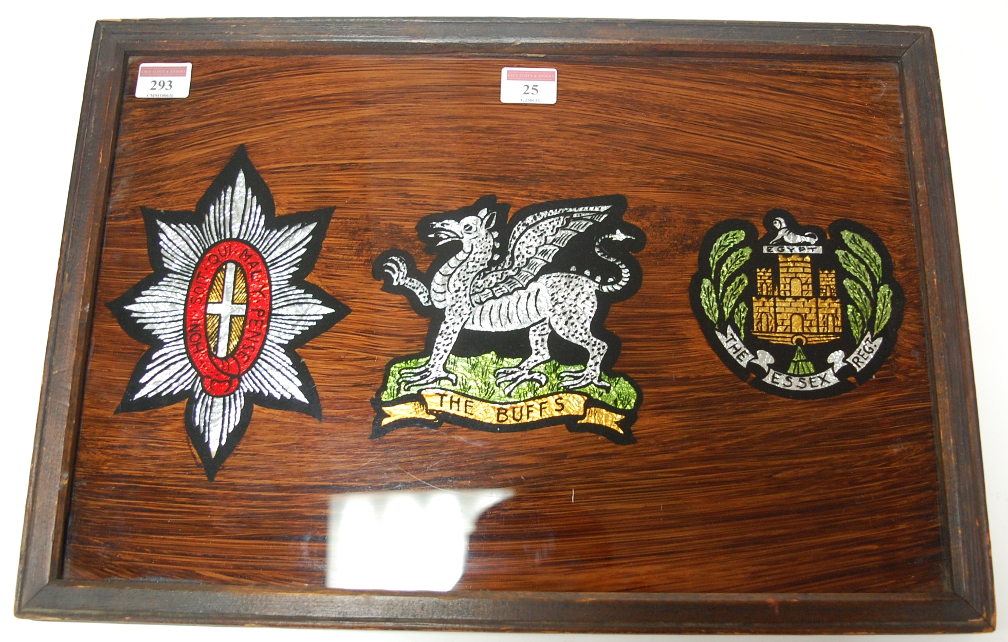 A faux rosewood and oak framed regimental plaque
