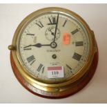 A mid 20th century Smiths brass cased ships clock having enamelled dial with Arabic numerals and