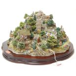 A large Lilliput Lane model of Coniston Crag on a wooden plinth, limited edition, No.