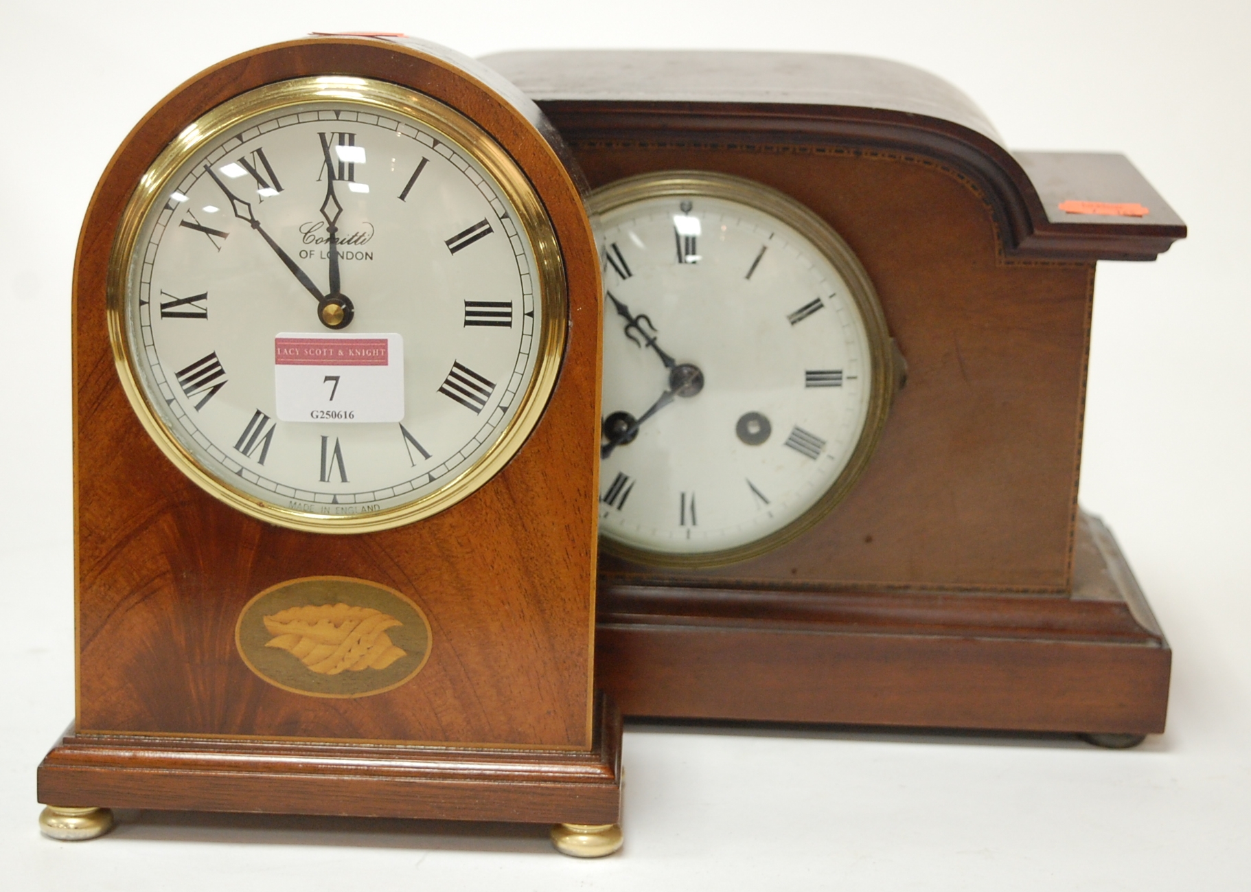An Edwardian mahogany and chequer strung mantel clock having an enamelled dial with Roman numerals