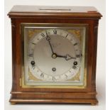 A mid 20th century walnut cased mantel clock by Eliot of London having a silvered dial with Roman