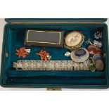 An early 20th century leather clad jewellery case and contents to include white metal filigree work