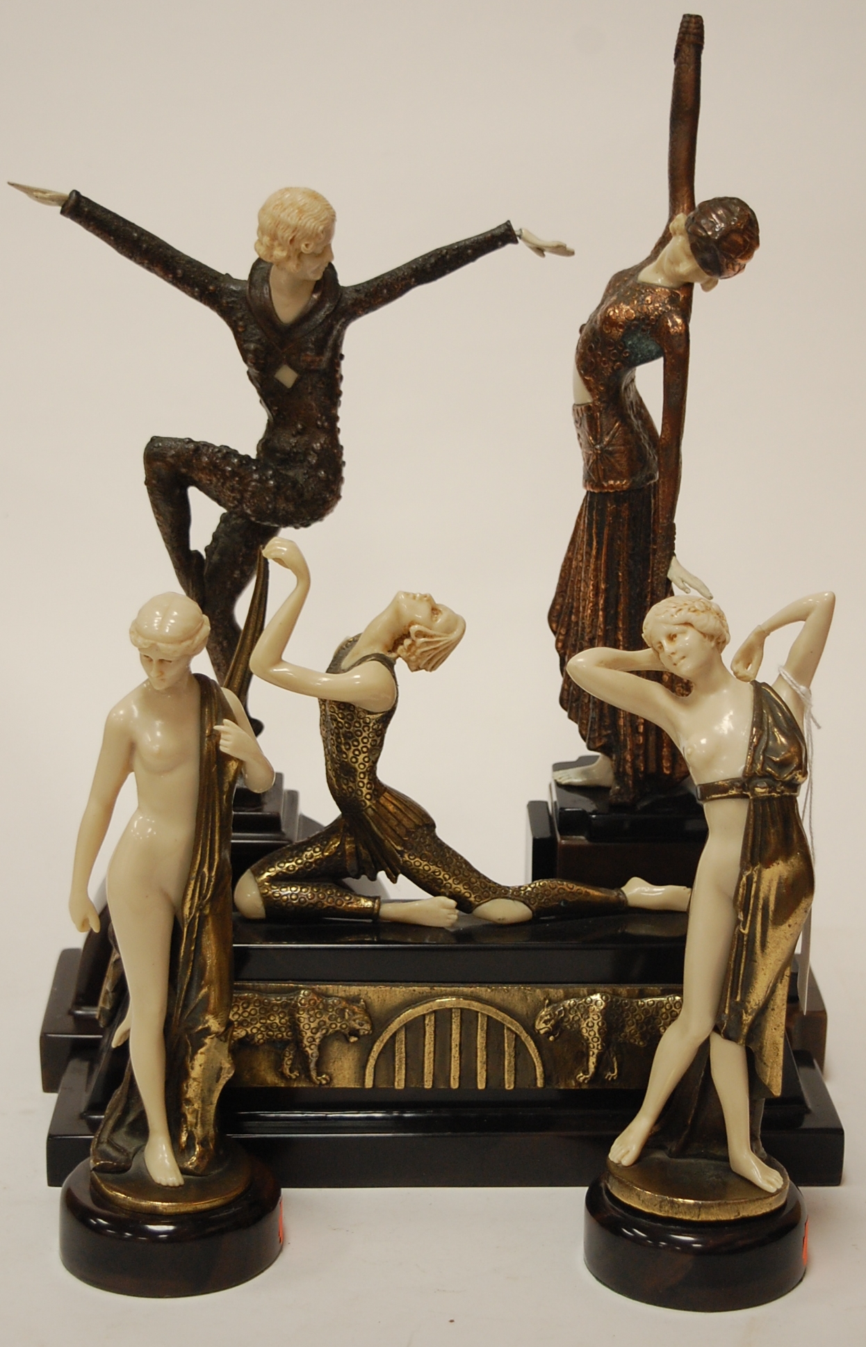 An Art Deco style figure of a dancer in standing pose with arms aloft on a marble base,