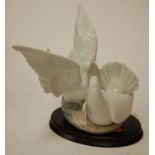 A large Lladro figure of doves impressed 6291 verso on a wooden plinth Condition Report /