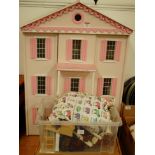 A large modern painted wooden dolls house and various dolls house furniture