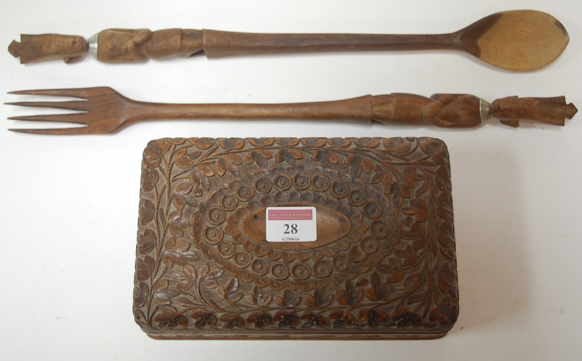 An early 20th century Anglo-Indian carved box together with an oversized pair of carved wooden fork