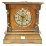 A late 19th century Continental walnut cased mantel clock having silvered dial with Arabic numerals