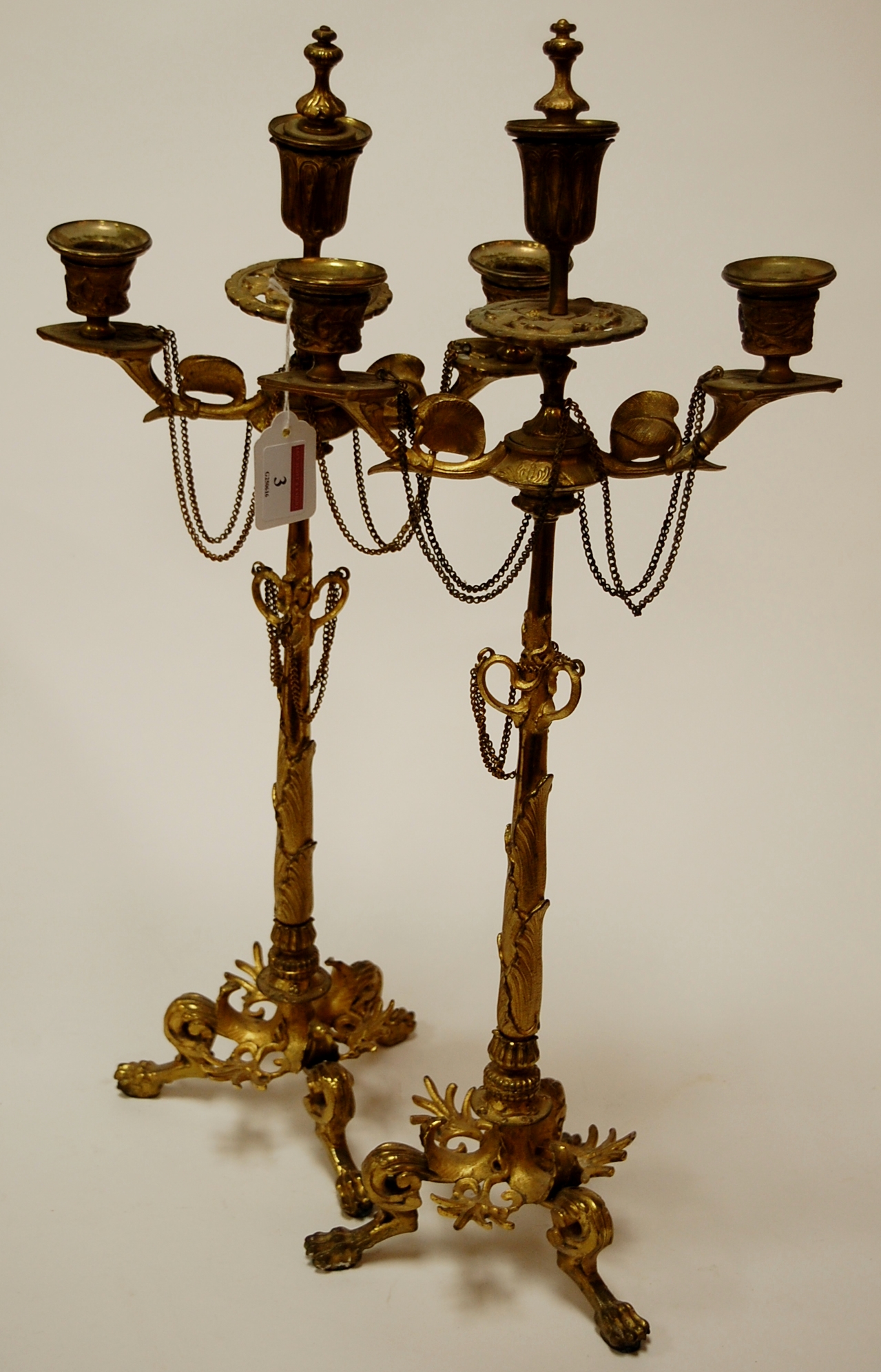 A pair of circa 1900 French gilt metal japonisme three-light candlesticks,