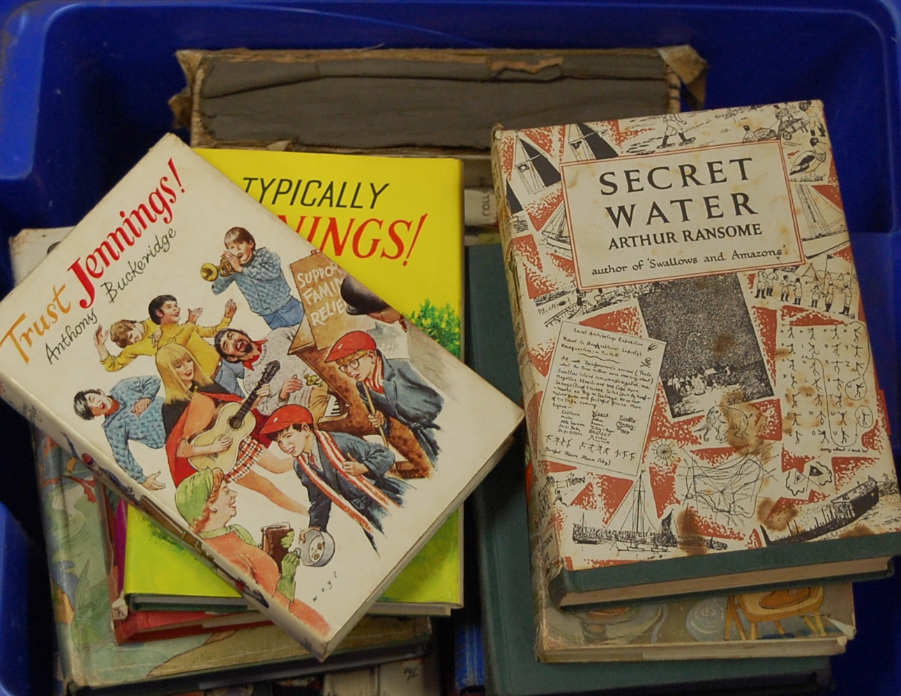A box of assorted books to include Secret Water by Arthur Ransome,