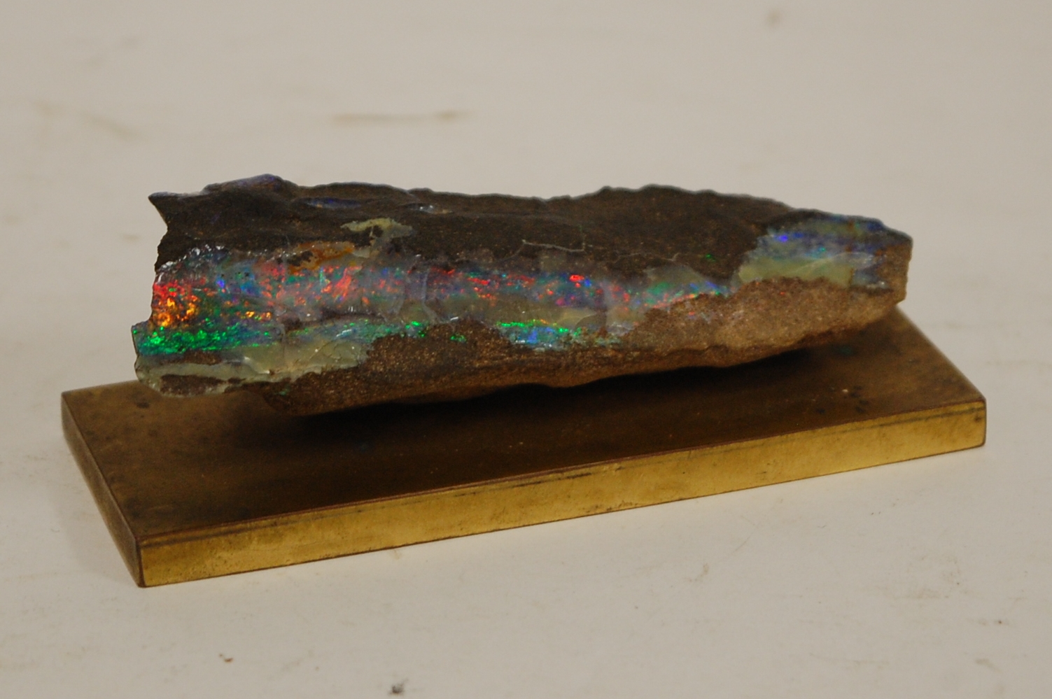 A specimen rock sample on a brass plinth