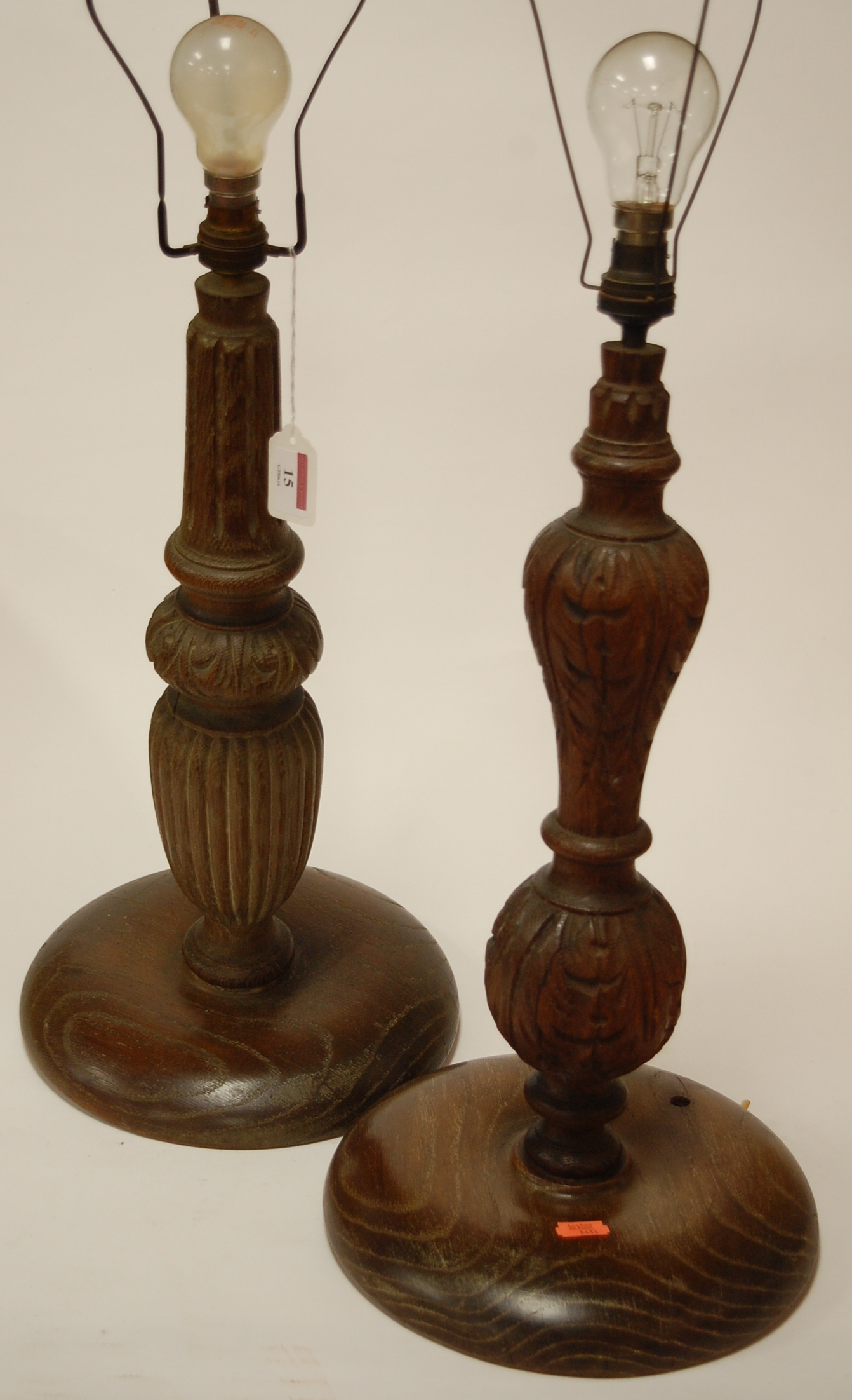 A carved oak table lamp base together with one other (2)