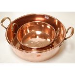 An early 20th century copper twin handled preserving pan together with one other smaller (2)