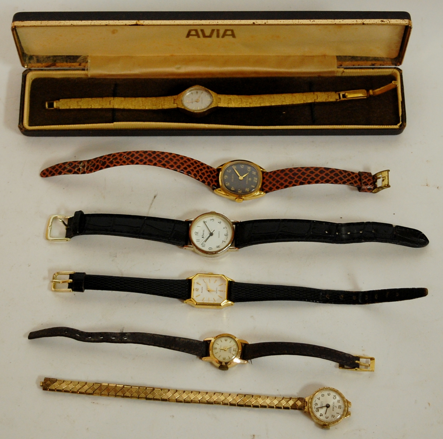 A ladies Aviva wristwatch having a plain oval dial with baton markers and textured gold plated