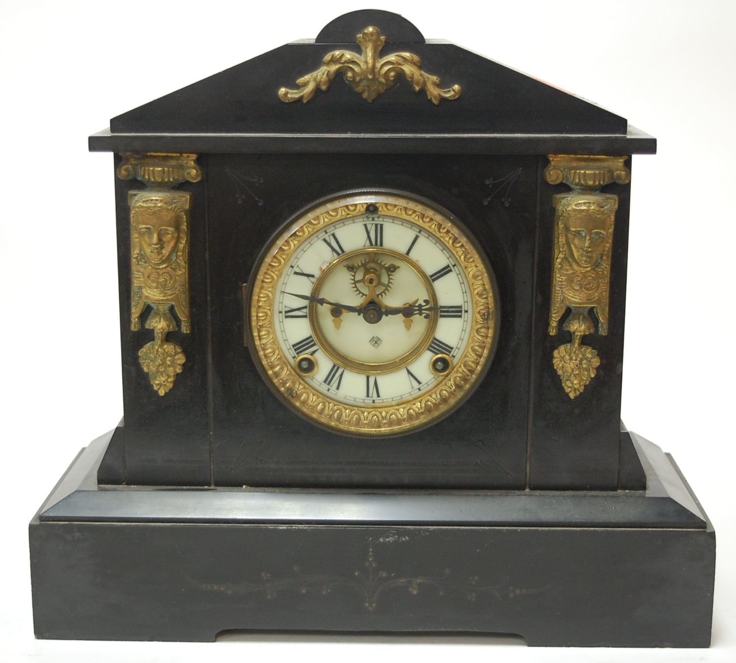 A late Victorian slate mantel clock of architectural form having an enamel dial with Arabic