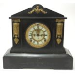 A late Victorian slate mantel clock of architectural form having an enamel dial with Arabic