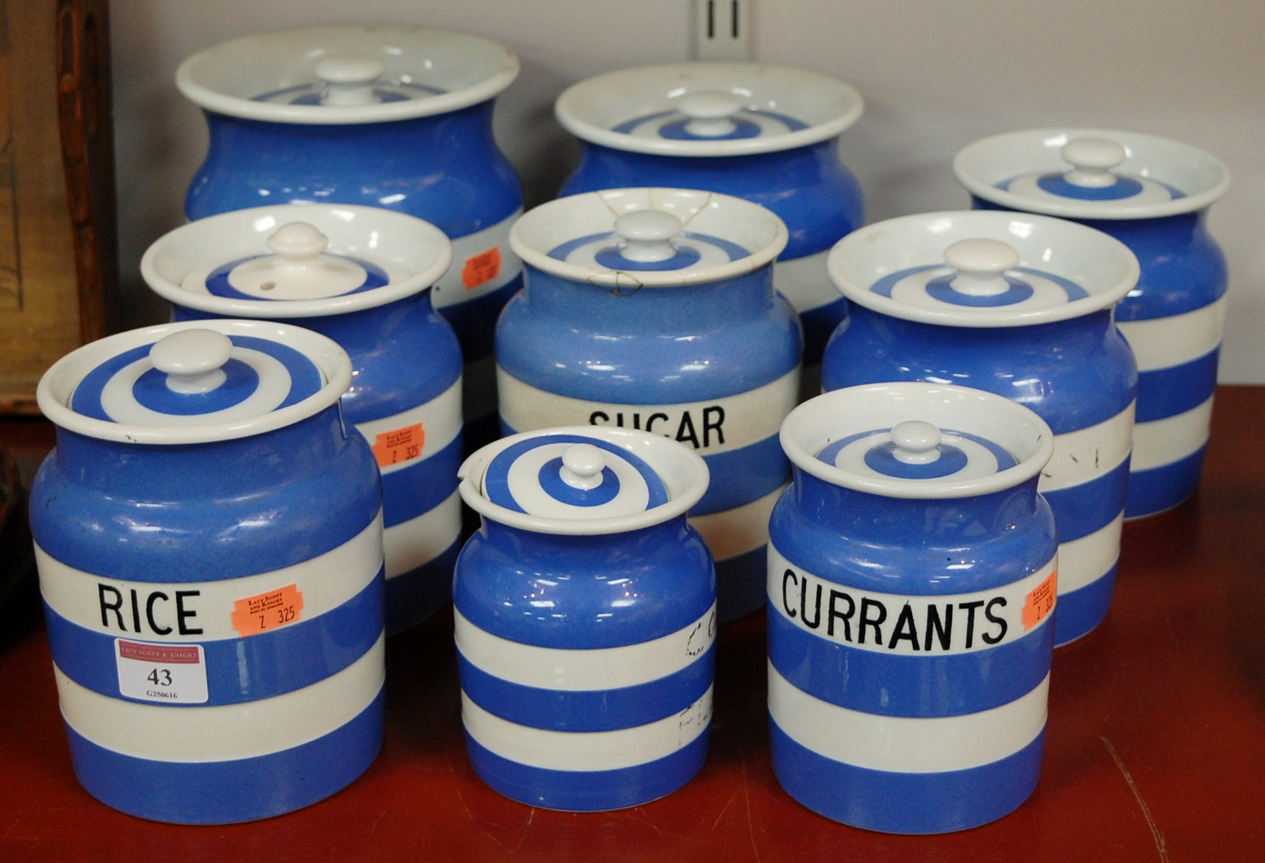 A collection of assorted Cornish ware storage jars to include rice, sugar, currants,